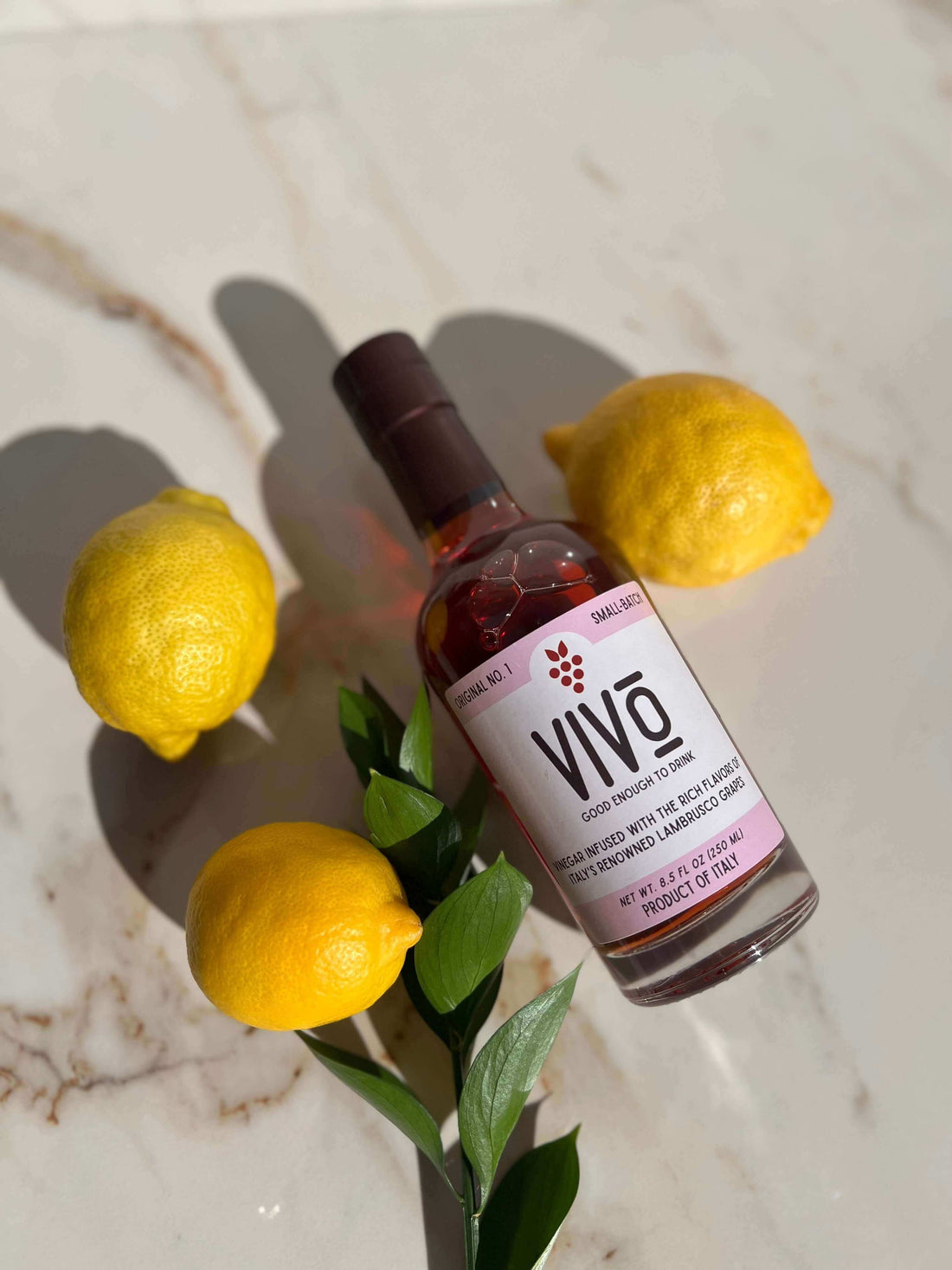 Bottle of VIVO Lambrusco Vinegar with lemons – Vivo is not vinegar, it’s a flavor experience