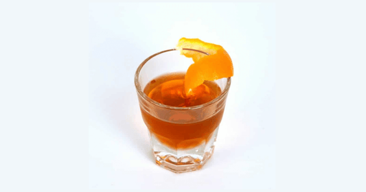 Lambrusco cocktail made with VIVO vinegar, served over ice in a rocks glass with an orange twist- bold, layered, and velvety