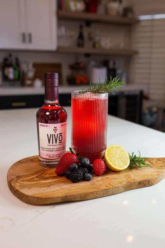Berry Bliss Fizz made with VIVO – Refreshing Lambrusco vinegar mocktail on a wooden board