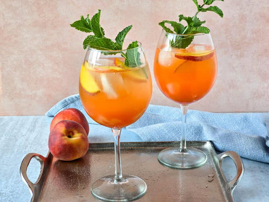 VIVO Peach Spritz cocktail with Lambrusco vinegar and fresh peach slices